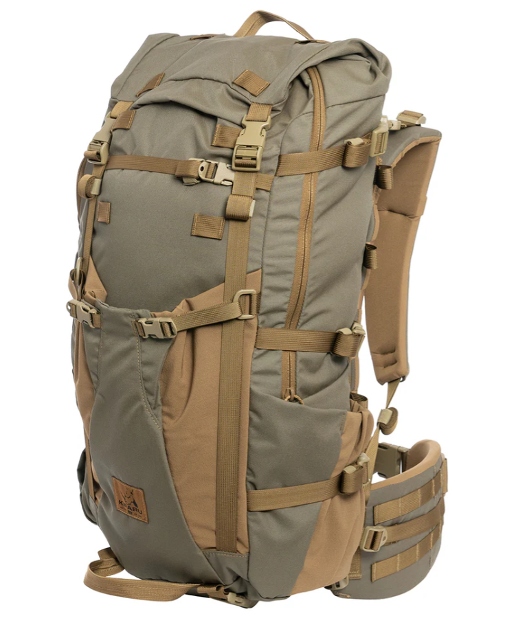 Kifaru Bedlam – Versatility, Access, and Loadout Efficiency The Kifaru Bedlam expands on the heritage of the Hoodlum and Hellbender, bringing together their best elements in a 3–4-day Duplex-compatible pack built for backcountry flexibility and access. Crafted from 500D Ranger Green Cordura with Coyote Brown 4-way stretch Tweave fabric and durable #8 YKK zippers, the Bedlam is made to handle tough conditions and dynamic hunts. With full-zip access and an asymmetrical pocket layout, you get fast, intuitive organization and the ability to grab your gear exactly when you need it. The left-side spotting scope pocket can accommodate items up to 20” tall, 9” wide, and 4” deep, secured by a single #8 zipper and multiple compression straps. On the right, a reinforced Tweave water bottle pocket fits two 32oz Nalgenes and secures tripods or similar items with an over-pocket strap. The main zip opens 2/3 of the way around the bag, allowing you to load from a stable bucket position and rapidly access contents from the top via reinforced pull loops. A Hellbender-style front pocket easily stores outer layers, snowshoes, wet items, or a folded chassis rifle, while ¾” webbing straps allow compression routing around bulky loads or weapon systems. The bottom handle supports carrying bow cams or tools like ice axes, and bottom-mounted K-clip straps are perfect for tents or sleeping pads. Dual hydration exits, an internal bladder sleeve, and a removable Chamber Pocket keep essentials close and hydration dialed. Components: 500D Ranger Green Cordura + 4-way stretch Tweave Asymmetrical zippered layout with full-zip side access Spotting scope pocket, water bottle pouch, front gear pocket Compatible with all Kifaru lids, Sherman Pocket, and Grabit Includes Chamber Pocket, K-clip straps, and hydration routing Duraflex Autolock buckles and Duplex frame compatible Notes: Designed for 3–4-day missions Ideal for gear-heavy hunts or extended scouting Built in the USA for maximum durability and modularity The Bedlam is built to maximize access and carry capability—perfect for the hunter who needs one pack to do it all.