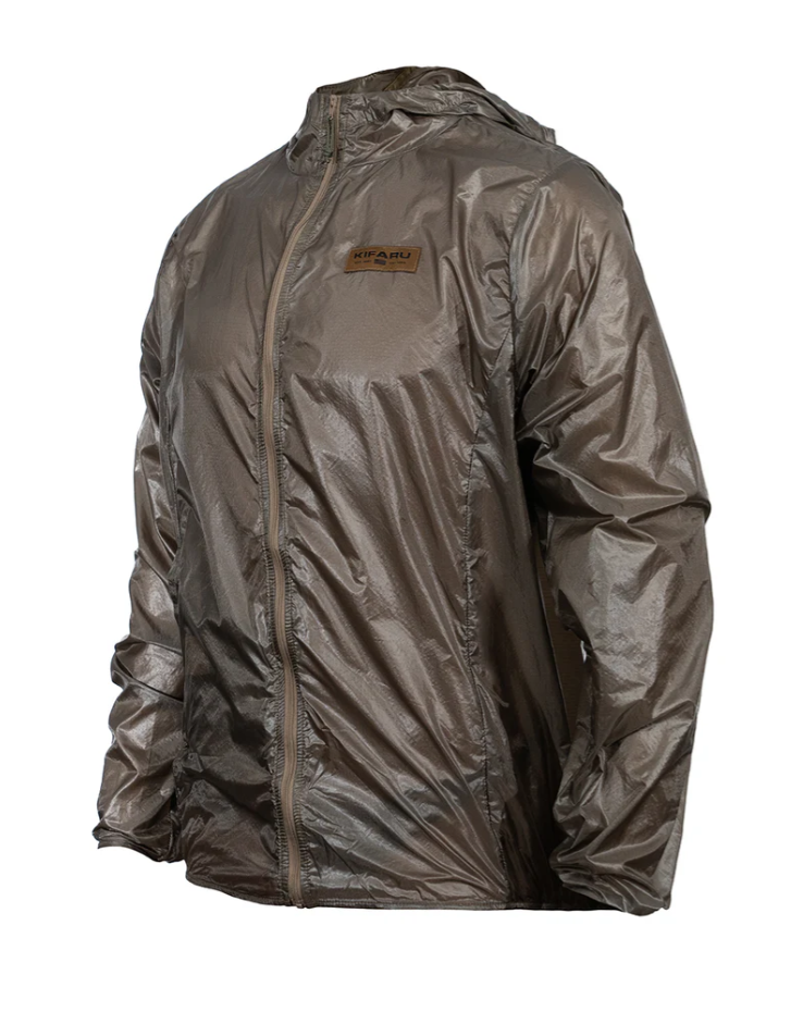 Kifaru Wind River Jacket – Lightweight Wind Layer with Packable Design Built for mountain hunts and high-output backcountry pursuits, the Wind River Jacket is the ultimate ultralight wind layer to round out your layering system. Constructed from 30D high-tenacity ripstop nylon, this jacket is designed to block wind without adding bulk or weight, making it an ideal piece to keep in your pack year-round. When the weather turns, the Wind River provides essential protection and breathability to keep you moving confidently in exposed terrain. One of the standout features of this jacket is its ability to pack into its own integrated front pocket. Once packed, it features a secure tab loop designed to attach directly to key hooks in Kifaru packs or other gear systems, ensuring it’s always within reach without taking up space inside your pack. Whether you’re glassing on a windy ridgeline or navigating gusty trails, the Wind River is a no-fuss solution to sudden weather shifts. Designed with ergonomics in mind, the Wind River features a hood, cuffs, and back hem fitted with integrated bungee. These subtle adjustments allow the jacket to move naturally with your body while maintaining a trim fit and sealing out the elements. While it’s not designed for rain, this jacket shines as a protective wind shell layered over your insulation or base layers. Components: 30D High Tenacity Ripstop Nylon Integrated Self-Pack Pocket with Gear Loop Tab Fitted Hood with Bungee Adjustment Elastic Cuffs and Hem for Secure Fit Ultralight & Compressible Construction Notes: Not waterproof—this is a wind shell, not a rain jacket Perfect as a top layer in dry but windy conditions Packs down to palm size and weighs next to nothing Stay prepared and protected without adding weight—Wind River Jacket is the wind-blocking layer you didn’t know you needed.