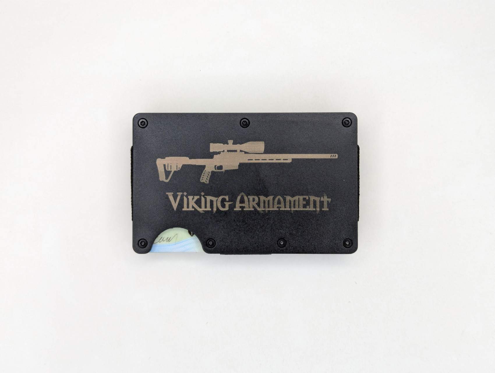 VA Wallet – Black Streamlined. Minimal. Built to last. The VA Wallet in Black is the perfect blend of function and form for anyone looking to slim down their carry without sacrificing capability. Crafted from lightweight, durable materials and engineered for a sleek, low-profile fit, this wallet is designed to handle the rigors of daily life while keeping your essentials secure. With RFID-blocking aluminum plates, it offers modern protection for your cards and identity. The compact design holds up to 12 cards comfortably and includes a robust cash strap to keep your bills tight and accessible. Whether you’re heading into the backcountry or out on the town, the VA Wallet delivers everyday reliability in a minimalist package. Machined hardware ensures the wallet stays rigid and secure, while its modular design allows for easy card access without unnecessary bulk. Its matte black finish gives it a sharp, tactical edge that pairs perfectly with your lifestyle—on or off the range. Components & Features: Lightweight, rugged aluminum construction RFID-blocking technology Elastic card retention – holds up to 12 cards Integrated cash strap Minimalist profile for front or back pocket carry Black anodized finish Notes: Durable enough for EDC, discreet enough for formal carry Designed for those who value both simplicity and performance 100% Made in the USA Elevate your everyday carry with the VA Wallet – where clean design meets real-world function. Ridge Wallet