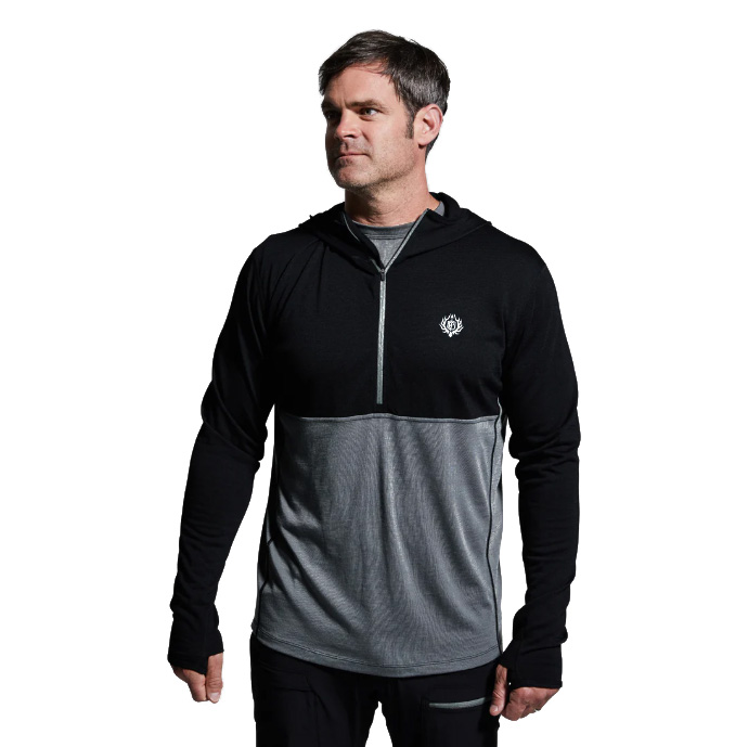 Men’s Ridgeline Half Zip Hoodie – Black The Ridgeline Half Zip Hoodie is built to be the cornerstone of your cold-weather layering system, offering premium performance from a lightweight, next-to-skin design. Crafted from a super-soft Merino wool blend, it delivers the perfect balance of warmth, moisture management, and comfort for extended use in the field. Merino’s natural properties make it one of the most versatile fibers available to hunters and outdoorsmen. It’s highly breathable, quick-drying, and antimicrobial, meaning it resists odor even after days of hard use. Unlike synthetic fabrics, Merino maintains its insulation value even when wet, keeping you warm and dry no matter how demanding the conditions. Combined with the added durability of synthetic fibers, this hoodie stands up to rugged use season after season. The half-zip design allows for easy temperature regulation—zip it up when the cold sets in or vent it quickly during strenuous climbs. A streamlined hood adds another layer of protection against wind and cold without excess bulk, making it ideal under mid and outer layers. Flatlock seams minimize chafing, while the athletic cut ensures unrestricted mobility, whether you’re glassing ridgelines, hiking deep into backcountry terrain, or sitting through long, frigid sits. Key Features: Merino Wool Blend – Soft, breathable, and naturally odor-resistant. Moisture-Wicking & Quick-Drying – Stays dry and comfortable during exertion. Half-Zip Venting – Allows quick heat release and easy layering. Streamlined Hood – Provides added warmth and coverage without bulk. Next-to-Skin Fit – Optimized for layering efficiency. Recommended Conditions: Cold to Frigid when paired with a mid layer and/or outer layer. Whether worn as a foundation piece or integrated into a full layering system, the Men’s Ridgeline Half Zip Hoodie is a must-have for serious hunters and adventurers facing unpredictable conditions.
