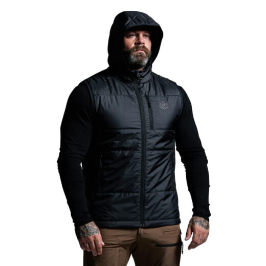 Men’s Tundra Vest The Tundra Vest is built for hunters who demand reliable warmth without sacrificing mobility. Designed as a hooded puff vest with 60g of premium synthetic insulation, it delivers exceptional thermal efficiency in a lightweight, packable form. Whether worn as a stand-alone piece during active hunts or layered under a shell in frigid conditions, the Tundra Vest provides the perfect balance of warmth, versatility, and freedom of movement. The synthetic insulation is engineered to perform even in damp conditions, retaining heat where down would falter. This makes the vest an ideal choice for unpredictable backcountry weather, ensuring your core stays warm during long glassing sessions, high-output stalks, or late-season hunts. The hooded design adds critical protection for your head and neck, sealing in warmth when the wind picks up or temperatures plummet. Built with a lightweight and compressible construction, the Tundra Vest packs down small for easy storage in your pack when not in use. Its minimal bulk ensures it layers seamlessly under outer shells or over lightweight base layers, adapting to a wide range of conditions. Reinforced stitching and durable fabrics ensure long-term reliability, while the streamlined athletic fit eliminates excess fabric that can snag on gear or brush. Whether you’re on the move, climbing ridges, or sitting still in cold weather, the Tundra Vest provides core warmth with unrestricted mobility—keeping you efficient, comfortable, and ready for whatever the hunt demands. Key Features: 60g Synthetic Insulation – Lightweight warmth, retains heat when wet. Hooded Design – Extra coverage and protection from the elements. Lightweight & Packable – Stows easily in a pack, layers without bulk. Durable Construction – Built for long-lasting use in rugged conditions. Recommended Conditions: Cool to Cold – Ideal as a mid-layer in frigid weather or a stand-alone vest during active hunts. The Men’s Tundra Vest is a versatile, field-proven insulation piece designed to keep you warm, mobile, and prepared for changing conditions.