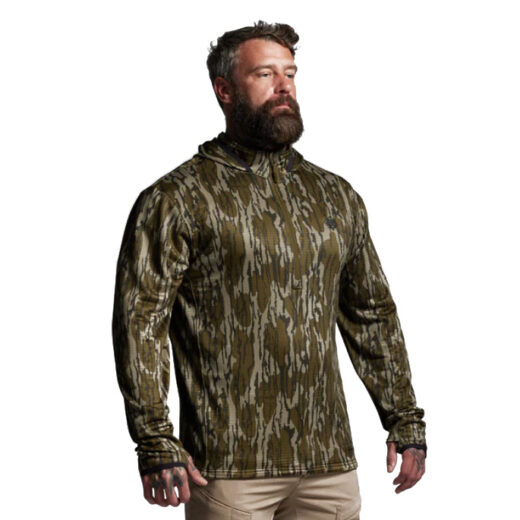 Quiver Half Zip Hoodie 2.0 – Mossy Oak® Designed for backcountry hunters who demand reliable performance across changing conditions, the Quiver Half Zip Hoodie 2.0 combines warmth, breathability, and packability in one versatile piece. Built from advanced grid fleece fabric, this hoodie delivers thermal efficiency without the excess bulk of traditional insulation, making it a true workhorse in any layering system. The grid-patterned interior is engineered to trap warm air close to the body for insulation while simultaneously allowing airflow to move through the channels. This dual-purpose design enhances breathability and moisture wicking, keeping you dry during high-output pursuits like climbing ridges, packing meat, or long hikes with a loaded kit. The result is dependable warmth when you’re stationary and effective cooling when you’re moving. A half-zip front closure provides quick and efficient temperature regulation—zip it up for added protection in biting winds or open it to dump heat during intense activity. The streamlined athletic fit layers comfortably under shells or outerwear without adding bulk, while flatlock seams minimize chafing during extended wear. Finished in Mossy Oak® camouflage, the Quiver 2.0 blends seamlessly into natural environments, giving you a stealth edge during critical moments in the field. Key Features: Grid Fleece Fabric – Lightweight warmth with enhanced airflow and moisture management. Grid Interior Design – Traps heat while promoting breathability. Half-Zip Venting – Quick regulation of body temperature. Streamlined Athletic Fit – Layers easily under mid and outer layers. Mossy Oak® Camo Finish – Proven concealment in diverse terrain. Recommended Conditions: 60°F to Frigid, when paired with the right layering system. From long days of scouting to frigid dawn hunts, the Quiver Half Zip Hoodie 2.0 – Mossy Oak® adapts to your pace, your terrain, and the elements—making it a must-have for the serious hunter.