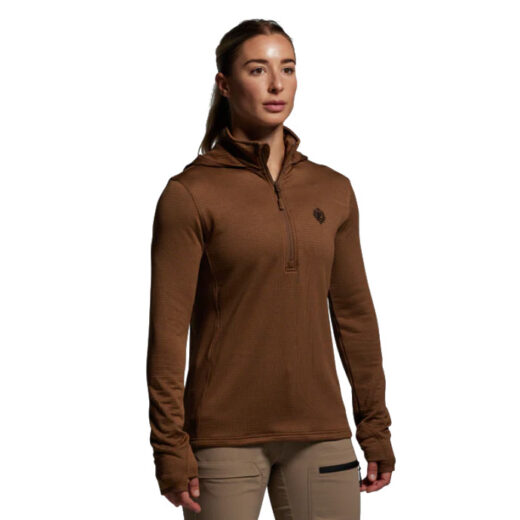 Women’s Quiver Half Zip Hoodie 2.0 The Women’s Quiver Half Zip Hoodie 2.0 is designed as the ultimate midlayer for active hunters who demand warmth without sacrificing breathability or mobility. Built with advanced grid fleece fabric, this hoodie leverages a technical interior pattern that traps warm air in small channels, creating efficient insulation while still allowing airflow to regulate body temperature. Unlike traditional fleece, the grid structure drastically reduces weight and bulk, making it ideal for layering under a shell or wearing as a standalone piece in mild to cool weather. When the exertion level rises, the Quiver’s moisture-wicking properties ensure sweat is pulled away from the skin, keeping you dry and comfortable. The half-zip design adds another layer of versatility, offering quick ventilation when you’re climbing steep ridges, hiking through dense timber, or simply transitioning from cold mornings to warmer afternoons in the field. Its athletic, streamlined fit not only eliminates unnecessary bulk but also ensures it won’t bind or bunch under outerwear, making it a true performance layering piece. This hoodie was designed with mobility in mind, offering a contoured cut and lightweight construction that moves with you whether you’re drawing a bow, shouldering a rifle, or glassing long ridgelines. Its packable nature also makes it easy to stow away in a pack when not needed, ensuring it won’t weigh you down in the backcountry. Key Features: Grid Fleece Construction – Retains heat efficiently while enhancing breathability. Moisture-Wicking Technology – Keeps you dry during high-output hunts. Half-Zip Design – Allows quick venting and easy temperature regulation. Streamlined Fit – Layers smoothly under jackets or shells. Lightweight & Packable – A versatile staple for backcountry layering systems. Whether used as a dependable midlayer or a standalone piece on brisk mornings, the Women’s Quiver Half Zip Hoodie 2.0 provides the technical performance required for serious hunters who prioritize comfort, adaptability, and efficiency in the field.