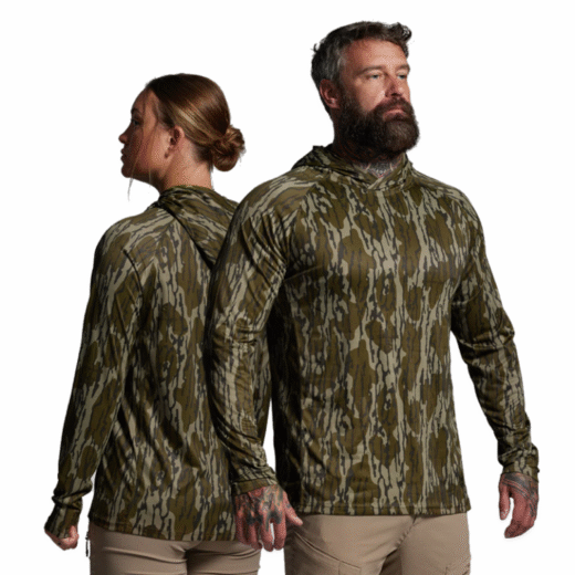 Sun Shirt 2.0 – Mossy Oak® The Sun Shirt 2.0 is engineered for peak performance in the hottest and harshest conditions, giving you the perfect balance of comfort, protection, and breathability during extended time outdoors. Whether you’re on the hunt, fishing, hiking, or working under direct sun, this shirt keeps you cool and protected so you can focus on the task at hand. Built from an ultra-lightweight, quick-drying fabric, the Sun Shirt 2.0 wicks moisture efficiently to keep you dry while maintaining maximum airflow. UPF 30 Block Technology shields your skin from harmful UV rays, while the integrated face mask and oversized hood provide extended coverage against sun, wind, and dust. Long sleeves with thumbholes add even more protection for your hands and wrists, making this shirt an essential layer for full-day exposure. Key Features: Lightweight & Quick-Drying Fabric – Keeps you cool and dry in extreme heat. UPF 30 Block Technology – Built-in UV protection against harmful rays. Integrated Face Mask & Oversized Hood – Shields face, head, and neck from sun, wind, and dust. Extended Sleeves with Thumbholes – Extra coverage for hands and wrists. Loose, Airy Fit – Maximizes airflow for all-day comfort. Notes: Best for hot climates and long days outdoors. Designed to layer easily over base garments or wear as a standalone shirt. The Sun Shirt 2.0 – Mossy Oak® is your all-day armor against the elements, built for those who demand lightweight performance and reliable protection in the field.