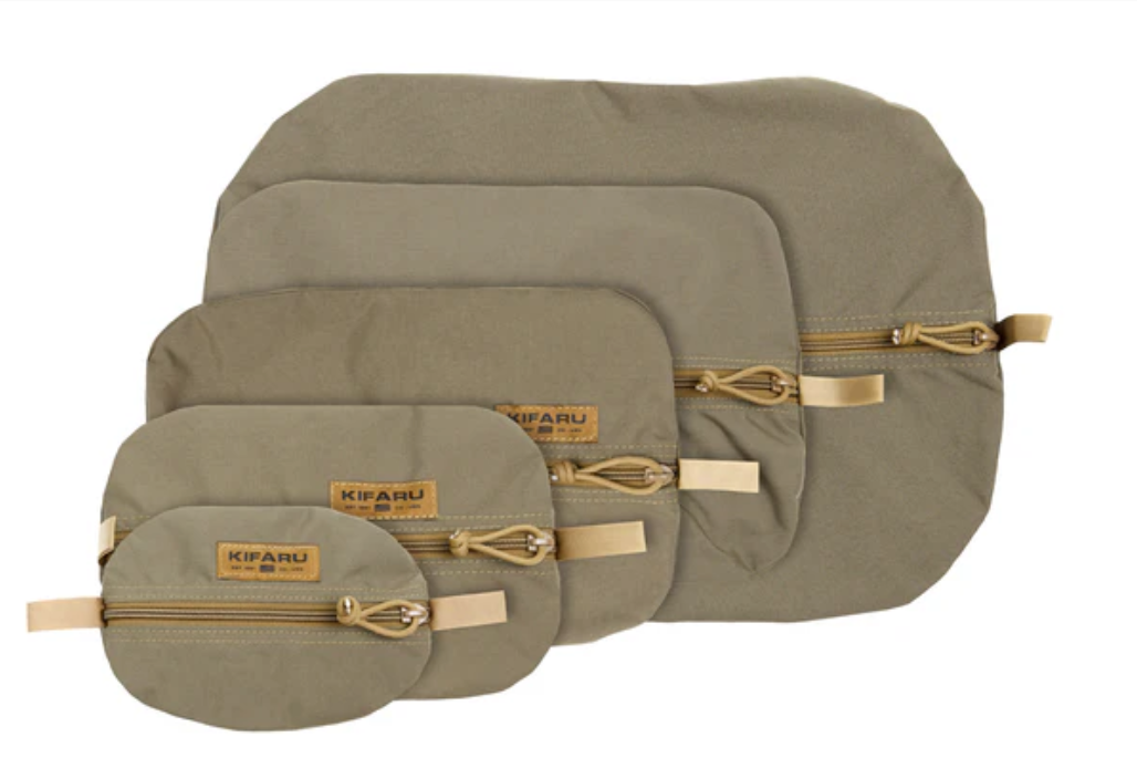 Kifaru Pullouts Kifaru Pullouts are the ultimate organizational upgrade for hunters, backcountry adventurers, and gear enthusiasts who demand efficiency and durability in every piece of their kit. Designed to streamline your loadout and eliminate the frustration of rummaging through your pack, these lightweight storage pouches offer exceptional visibility, rugged reliability, and modular flexibility—making them a staple for anyone who values fast, intuitive gear management in the field. Crafted from ultra-durable materials with Kifaru’s signature attention to detail, Pullouts are built to withstand the harsh realities of backcountry use. The combination of reinforced stitching, robust zippers, and abrasion-resistant construction ensures they perform season after season, whether exposed to dust, mud, moisture, or constant shifting inside your pack. The semi-rigid yet flexible design helps maintain shape without adding unnecessary weight, supporting quick access even when tightly packed. One of the standout features of Kifaru Pullouts is their high-visibility interior. This thoughtful design allows you to instantly identify gear, even in low-light conditions or during high-pressure moments. Whether you’re sorting first-aid supplies, spare layers, ammo, optics accessories, snacks, electronics, or emergency items, each Pullout keeps contents neatly contained and easily accessible. Available in multiple sizes, they offer customizable organization to match your pack system, hunting style, and mission requirements. Because they integrate seamlessly with any pack—especially within Kifaru’s ecosystem—Pullouts allow users to build a dialed-in layout tailored to fast movement and quiet operation. Their minimal weight makes them ideal for ounce-conscious hunters and ultralight packers, while their durability ensures they can adapt to the heaviest, roughest, and most demanding expeditions. Whether you’re fine-tuning your pack for a multi-day hunt or keeping everyday essentials ready for quick deployment, Kifaru Pullouts deliver unmatched simplicity, strength, and organization. Add them to your system and experience the efficiency of a truly optimized loadout.