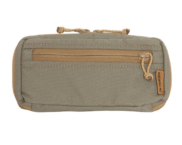 Kifaru Navigation Pouch The Kifaru Navigation Pouch is purpose-built for hunters, backcountry explorers, and tactical users who rely on fast, organized access to essential navigation tools. Designed with Kifaru’s signature durability and modular efficiency, this pouch provides a streamlined storage solution for GPS units, rangefinders, compasses, maps, notepads, and other mission-critical items that need to stay secure, protected, and immediately accessible in the field. Constructed from premium, high-denier materials and reinforced with bombproof stitching, the Navigation Pouch is engineered to withstand harsh environments—from dense timber and rocky alpine terrain to high-desert dust and unpredictable weather. Its semi-rigid structure maintains shape for easier one-handed operation, while the interior is thoughtfully laid out to maximize efficiency. Elastic loops, divider pockets, and a spacious main compartment make it simple to keep your gear organized and prevent delicate items from shifting or rattling. The exterior features a robust zipper system for reliable access, along with modular attachment points that integrate seamlessly with Kifaru packs, belts, chest rigs, or other MOLLE/PALS-compatible gear. This versatility allows the Navigation Pouch to be positioned exactly where you need it—whether that’s on your pack’s shoulder strap for quick on-the-go access, on the belt for minimalist setups, or mounted externally for rapid retrieval during high-pressure situations such as stalks or navigation checks. Slim, lightweight, and highly functional, the Navigation Pouch delivers exceptional accessibility without adding unnecessary bulk. Its weather-resistant design helps protect electronics and paper materials from moisture, dust, and abrasion, ensuring your navigational tools remain operational when conditions turn rough. For hunters and adventurers who depend on dependable gear management, the Kifaru Navigation Pouch provides a rugged, efficient, and highly adaptable storage solution—engineered to keep your critical navigation equipment organized and ready at a moment’s notice.