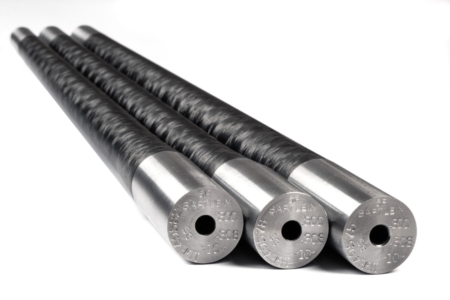 The Bartlein Carbon Fiber Wrapped Barrel Blank combines the legendary accuracy of Bartlein’s cut-rifled barrels with modern carbon fiber technology to create a lightweight yet extremely rigid barrel platform. Bartlein Barrels are widely respected throughout the precision rifle community and are used by competitive shooters, custom rifle builders, and military teams around the world. Their barrels are produced using single-point cut rifling, a process known for creating extremely uniform bore geometry while minimizing internal stress in the steel. This results in excellent consistency, repeatability, and long-term accuracy potential. Each Bartlein carbon barrel begins with a precision cut-rifled stainless steel barrel core, which is drilled, reamed, honed, and rifled to extremely tight tolerances. The barrel core is then wrapped in high-strength carbon fiber that significantly reduces overall barrel weight while maintaining rigidity. Compared to traditional all-steel barrels of similar contour, carbon wrapped barrels can provide approximately 20–25% weight reduction, making them extremely attractive for lightweight hunting rifles and backcountry builds. Bartlein carbon barrels are available in multiple calibers, twist rates, contours, and finished lengths, allowing gunsmiths to configure the barrel for specific cartridges and rifle platforms. Common contours include configurations similar to Remington Varmint/Sendero and M24/M40 profiles, which provide excellent rigidity while still maintaining reduced weight. Because these are supplied as unfinished barrel blanks, they allow a gunsmith to cut the chamber, thread the muzzle, and machine the tenon to match the exact action and cartridge specifications of the rifle being built.