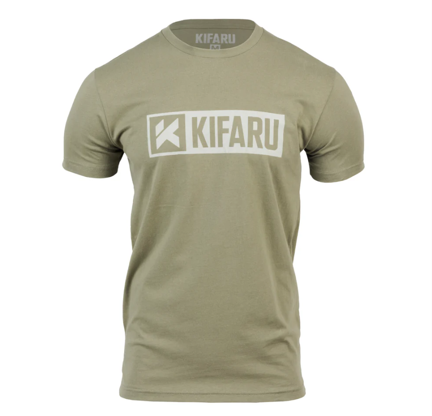 Kifaru Logo T-Shirt – Tan Show your support for one of the most trusted names in backcountry gear with the Kifaru Logo T-Shirt. Simple, rugged, and comfortable, this everyday tee carries the iconic Kifaru logo proudly across the chest — a mark recognized by serious hunters, backpackers, and adventurers who rely on Kifaru gear when it matters most. Key Features Classic Kifaru Logo – Clean front graphic featuring the unmistakable Kifaru branding. Premium Cotton Blend – Soft, breathable fabric that feels great in all-day wear. Athletic Fit – Designed for comfort and mobility without being too loose or too tight. Versatile Style – Ideal for casual wear, range days, or representing your backcountry lifestyle. Durable Print – High-quality screen printing that stands up to repeated washes. Why It Stands Out The Kifaru Logo Tee isn’t just a shirt — it’s a badge of loyalty to a company built on performance, durability, and real-world experience in the field. Lightweight yet durable, it’s equally at home on the mountain, around camp, or as your go-to casual shirt. The tan color makes it versatile, easy to pair with any gear, and subtle enough for everyday wear while still showing your connection to the Kifaru community. Specs Material: Cotton/poly blend Color: Tan Fit: Regular/Athletic The Kifaru Logo T-Shirt – Tan is more than casual wear — it’s a statement of the lifestyle you live and the gear you trust.